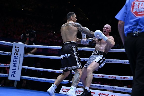 A big right hand by Williams sends Hall to the ropes.