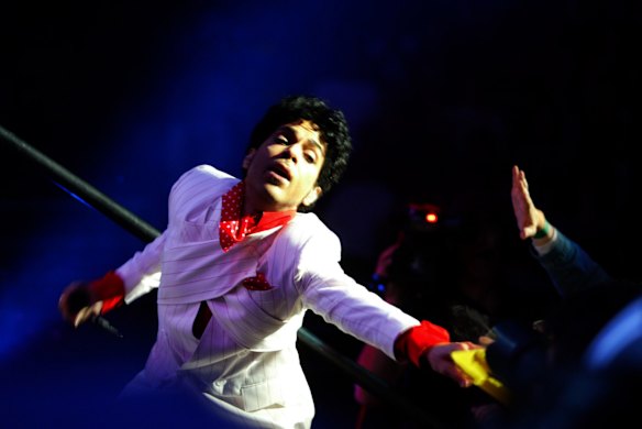 Prince reaches out to fans during a performance at the Rod Laver Arena, Melbourne in 2003. 