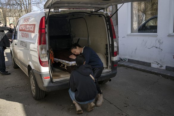 Oksana Kolesnikova embraces the coffin of her son Anatoliy Kolesnikov, 30, a territorial defence soldier who was killed by Russian soldiers in Irpin, on the outskirts of Kyiv.