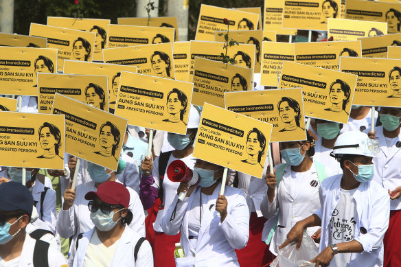 Medicals students display images of deposed Myanmar leader Aung San Suu Kyi during a street march in Mandalay, Myanmar.