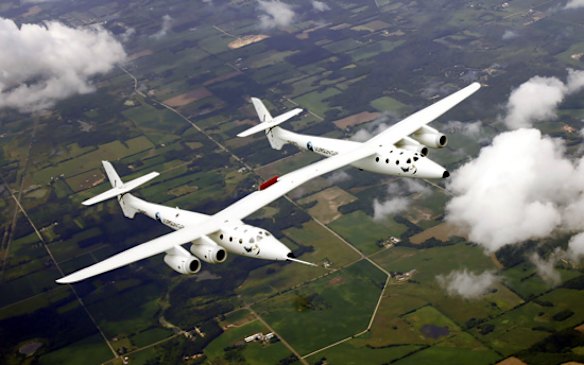 Virgin WhiteKnightTwo, nicknamed Eve, designed by Burt Rutan and financed by Richard Branson, approaches the Wittman Field site of the Experimental Aircraft Association Convention in Oshkosh, Wisconsin.