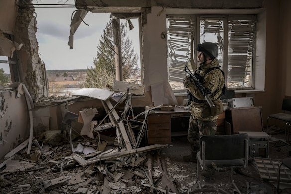 A Ukrainian serviceman stands in a heavily damaged building in Stoyanka. Ukrainian President Volodymyr Zelenskyy accused the West of lacking courage as his country fights to stave off Russia's invading troops, making an exasperated plea for fighter jets and tanks to sustain a defense in a conflict that has ground into a war of attrition.