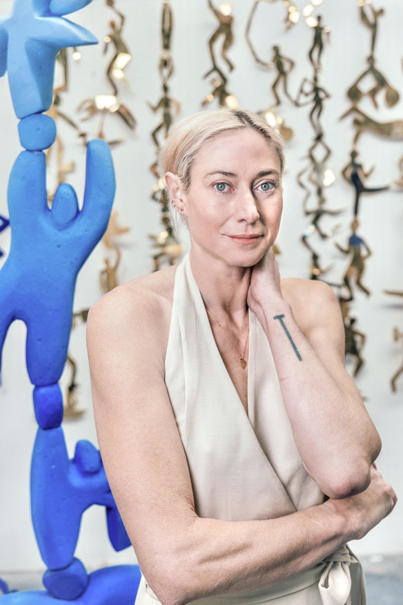 Olympian and sculptor Clementine Stoney Maconachie with her sculpture on display as part of the Olympic Games in Paris. 