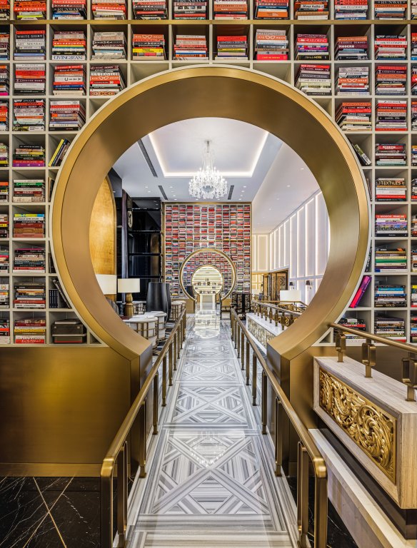A book lounge features striking custom shelving stacked with 4000 hand-picked books.