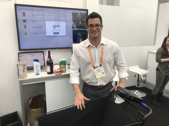 Michael Cantalino from Focal Systems with the company's automated trolley.  