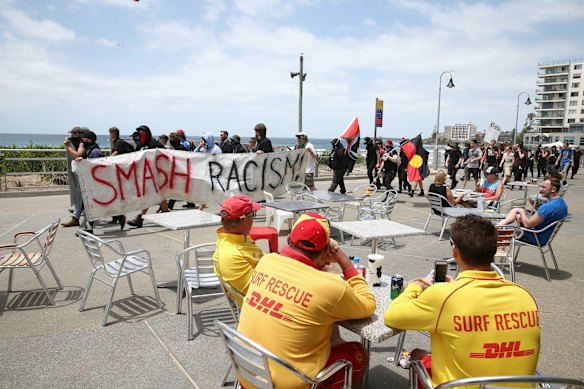 The anti-racism rally marches along the beach in Cronulla.