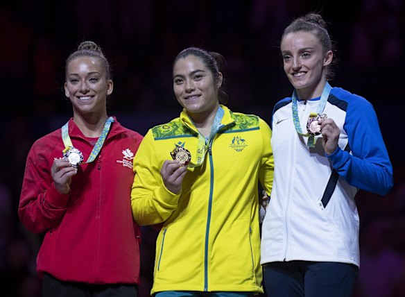 Canada's Laurie Denommee, silver; Australia's Georgia Godwin, gold; and Scotland's Shannon Archer, bronze, from left, stand on the podium after the artistic gymnastics vault finals in Birmingham Arena at the Commonwealth Games in Birmingham, England on Monday, Aug. 1, 2022. (Andrew Vaughan/The Canadian Press via AP)