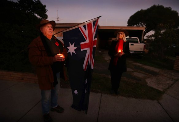 People pay their respects in the driveways of their homes in Daff Ave, Hampton East. Sandy Rose, and George Schmitz