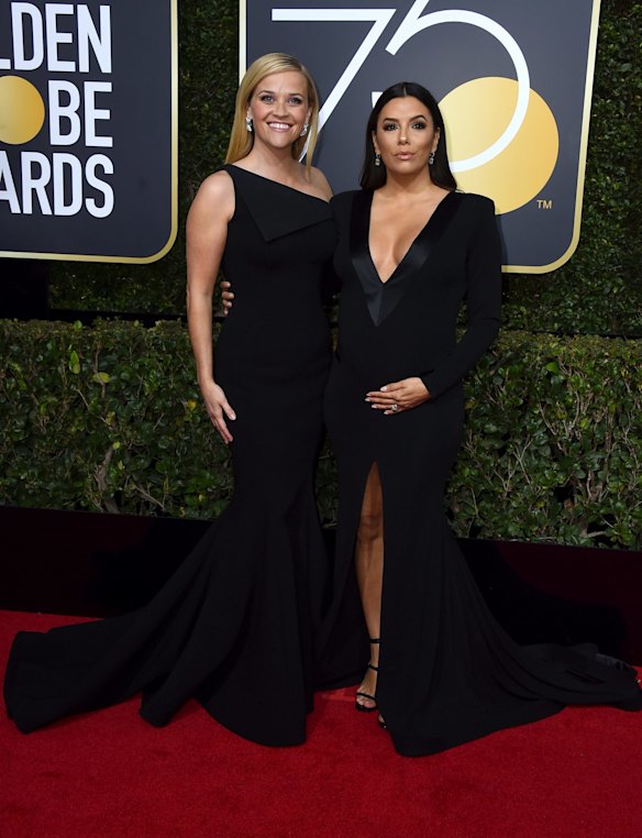 Reese Witherspoon, left, and Eva Longoria arrive at the 75th annual Golden Globe Awards. Witherspoon wears Zac Posen.