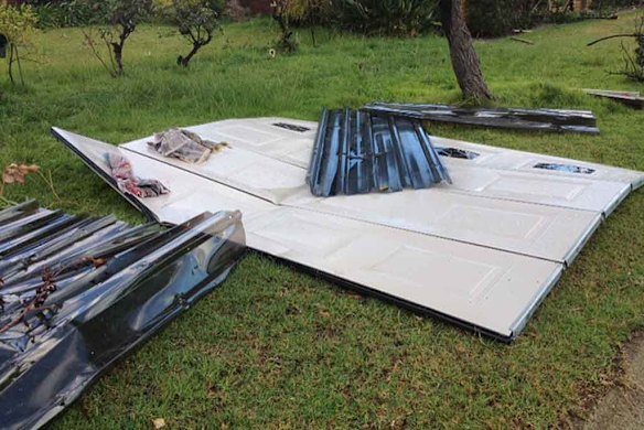 The remains of a patio spread across a backyard.