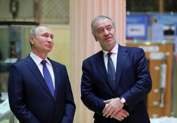 Russian President Vladimir Putin, left, and Mariinsky Theatre’s Artistic Director Valery Gergiev talk to each other as they visit an exhibition at the Russian military’s headquarters as part of a conference on the Russian campaign in Syria in Moscow, Russia, Tuesday, Jan. 30, 2018.