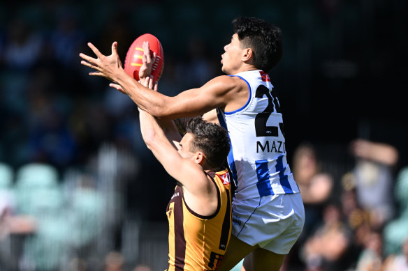 North Melbourne forward Paul Curtis battles for a mark against Hawthorn on Saturday.