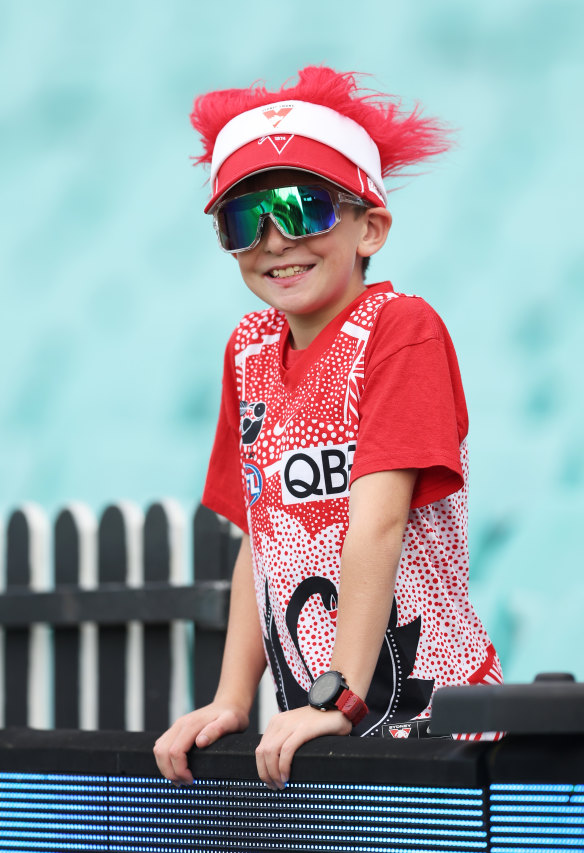 A Swans fan looks on.