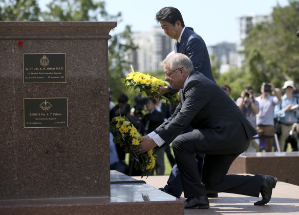 Mr Abe lays a wreath along with Mr Morrison. The Japanese PM is on a two-day visit to Australia.