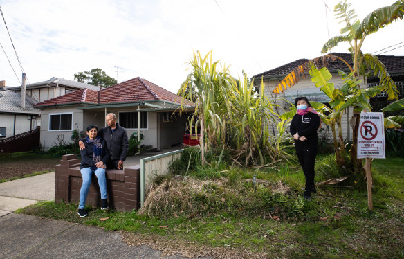 Sam and Monika Charan, with neighbour Elane He, will lose their homes to a car park as part of the federal government’s Commuter Car Park Fund.
