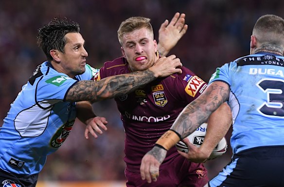 Cameron Munster of the Queensland Maroons is tackled by Mitchell Pearce.