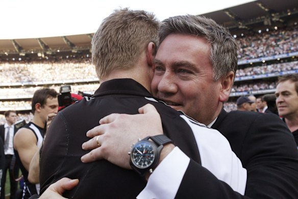 Magpies assistant coach and former captain Nathan Buckley is embraced by President Eddie McGuire after Collingwood won their first premiership in 20 years.
