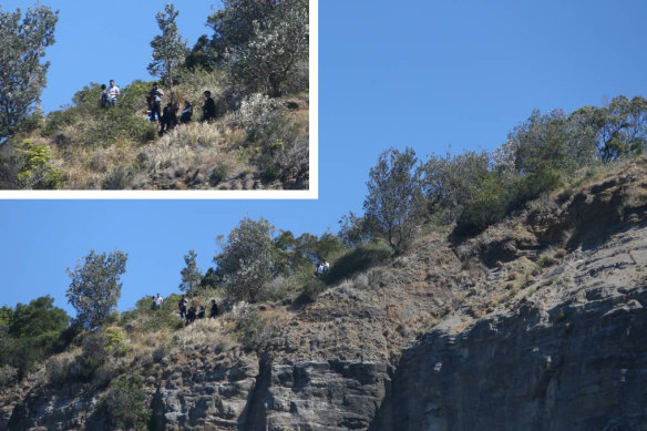 People posing for a photo at Sea Cliff Bridge just 48 hours after a man fell to his death at the same location. 