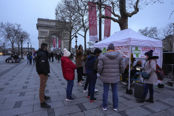 People line up to get a nasal swap at a mobile COVID-19 testing site in Paris. 