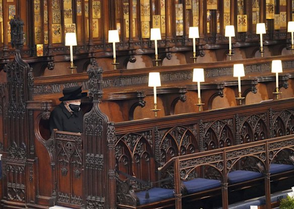 Britain's Queen Elizabeth II sits alone in St. George's Chapel.