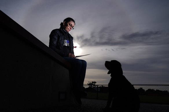 Libby Haverfield holds a photograph of her father, who served for the New Zealand Air Force in WWII, on AnzacDay in Melbourne.