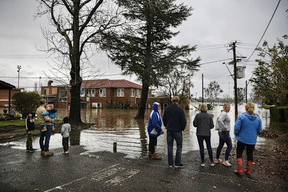 Residents stand on the shores watching the water rise in Camden.