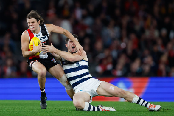 Outta my way: Saint Hunter Clark shrugs off a tackle by Patrick Dangerfield at Marvel Stadium on Saturday night.