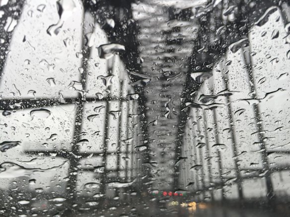 Driving over the Sydney Harbour Bridge in a deluge of rain.