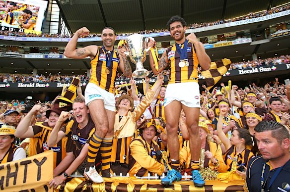 2015 Shaun Burgoyne and Cyril Rioli celebrate with the AFL Premiership Cup after Hawthorn won the 2015 AFL Grand Final match against the West Coast Eagles.