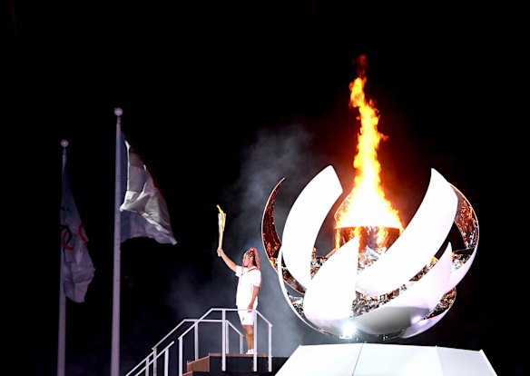 Tennis player Naomi Osaka lights the Olympic cauldron to kick off the Olympic Games.