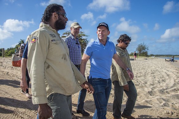Off for a day at the beach - Prime Minister Tony Abbott walks the beach at the mouth of the Jardine River with indigenous Apudthama Land and Sea Rangers on Friday 28 August 2015.