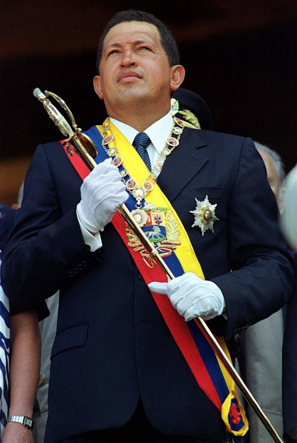 In this July 24, 2000 file photo, Venezuela's President Hugo Chavez holds Simon Bolivar's sword at an event celebrating the independence hero's 114th birthday in Caracas, Venezuela.