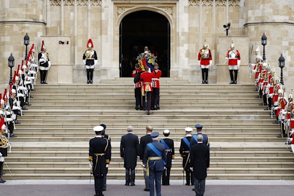 Pall bearers carry the coffin of Queen Elizabeth II with the Imperial State Crown resting on top into St. George's Chapel in Windsor.