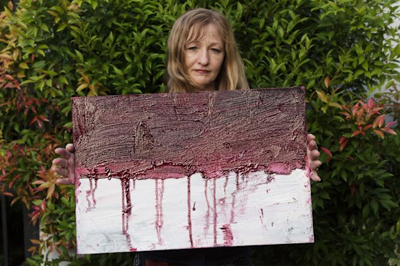 Sukumaran's painting teacher Tina Bailey holds a painting of the Indonesian flag dripping with blood, created on the day before Myuran Sukumaran's execution.