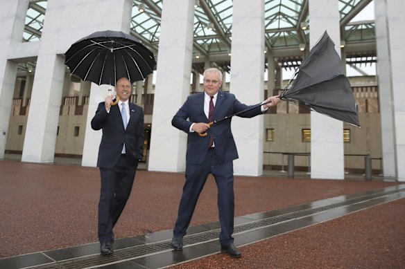 Treasurer Josh Frydenberg and Prime Minister Scott Morrison arrive for post-Budget day breakfast television interviews on the front lawn of Parliament House in Canberra. 