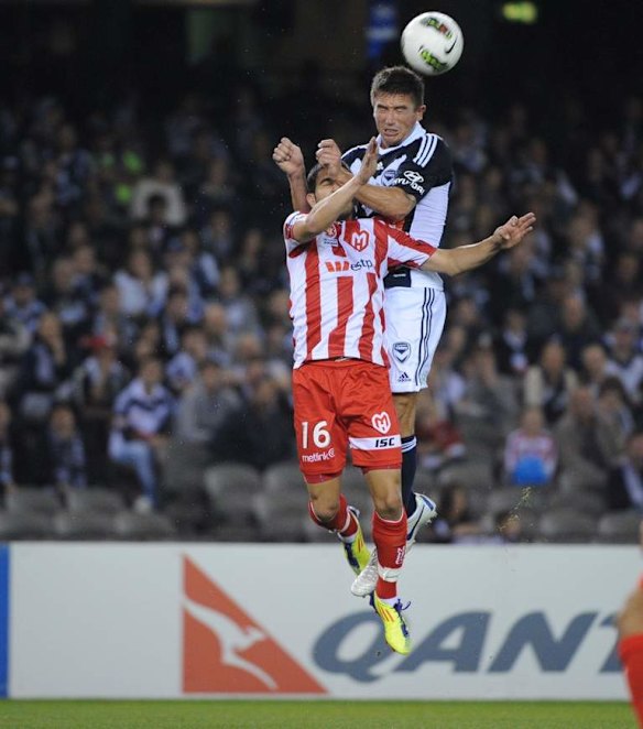 Melbourne Victory v Sydney at Etihad Stadium.   Harry Kewell and Aziz Behich. 8th October 2011