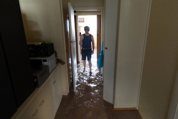 John walks through his flooded South Shepparton home. 