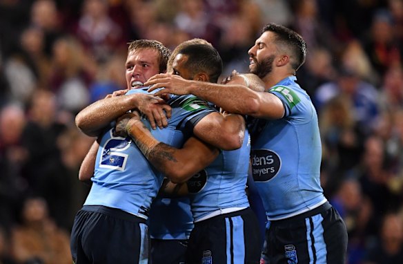 Tom Trbojevic (left) of the Blues celebrates scoring a try.