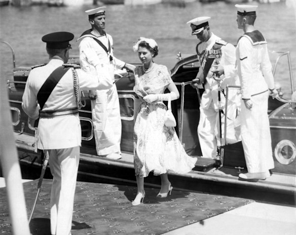 The historic moment at Farm Cove when Queen Elizabeth II, followed by the Duke of Edinburgh, leaves the barge to the salute of the governor-general, Sir William Slim, and the cheers of citizens who had awaited this moment for hours in 1954.