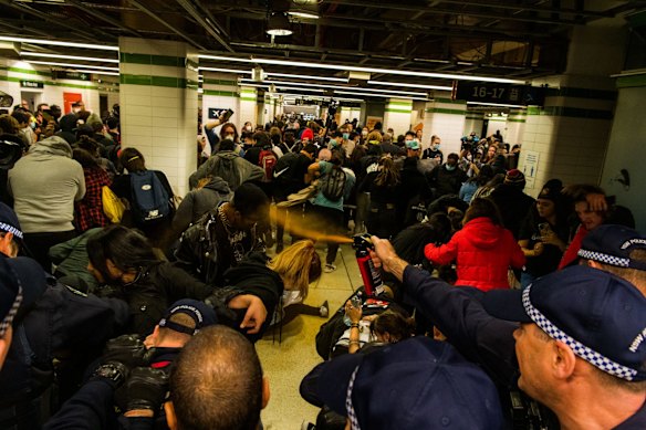 A small group clash with police at Sydney Central Station.