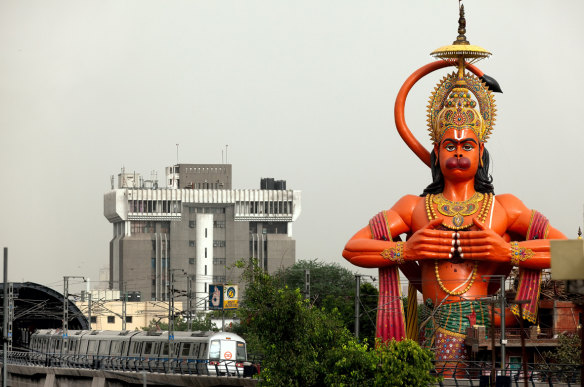 A huge statue of Hanuman looms over a Delhi railway station.