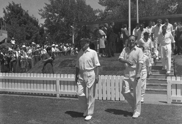 Sir Donald Bradman, left, leads the  Prime Minister’s XI on to Manuka Oval on February 6, 1963.