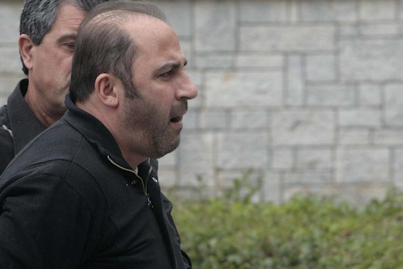 Tony Mokbel arrives at Athens' Korydallos prison in May 2008 before being flown back to Australia.