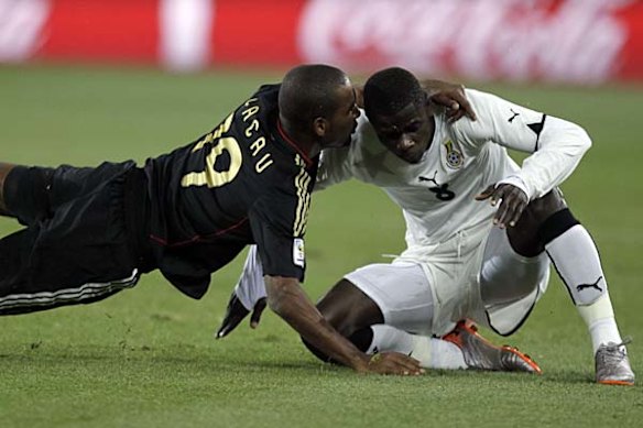 Germany's Cacau, left, and Ghana's Jonathan Mensah collide.