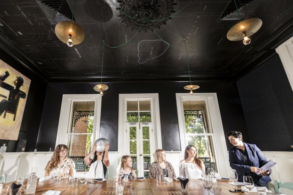 Angie Giannakodakis of Epocha (right) explains good table etiquette to Stefany, Lani, Ann and Laura, as Dani Valent (second from left) embraces bad table manners.