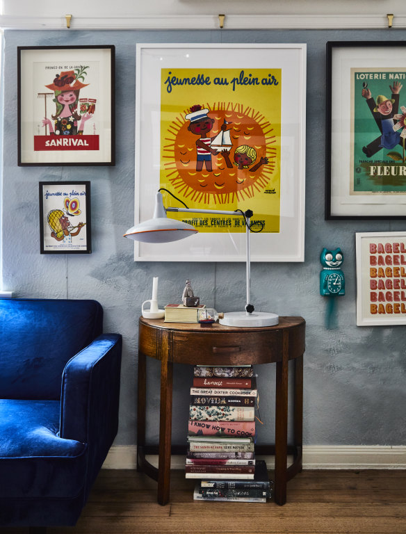 Paula’s French advertising posters and vintage furniture are set against a wall painted in a mix of half and full-strength Porter’s Paint “Hailstorm” colour.