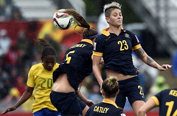 Brazil's midfielder Formiga, Australia's defender Laura Alleway and Australia's forward Michelle Heyman jump for tha ball.
