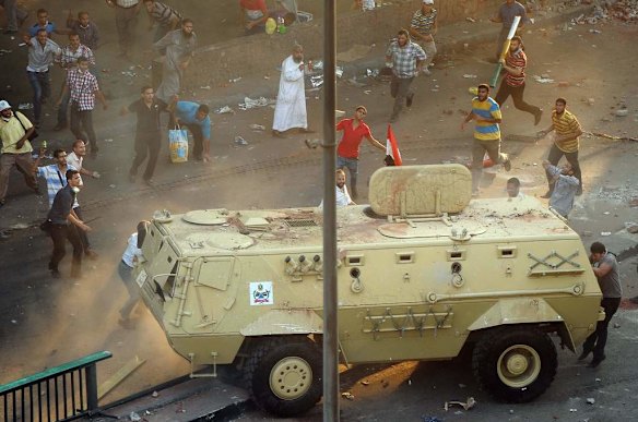 Supporters of ousted Islamist President Mohammed Morsi capture an Egyptian security forces vehicle at the Ministry of Finance in Cairo, Egypt.