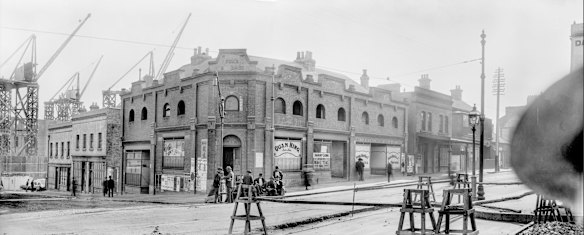 Panorama showing Fox's Buildings, Pitt and Goulburn streets, 1902. This panorama, composed from two separate glass plates, shows the northwest intersection of Pitt and Goulburn streets around 1902. Tall cranes in the distance are busy constructing Anthony Hordern & Son's enormous new retail emporium on Brickfield Hill. A number of Chinese businesses, factories and lodging houses rented shopfronts in Fox's Buildings opposite, including Quan Hing's store and Kwong Mow On & Co, importers.