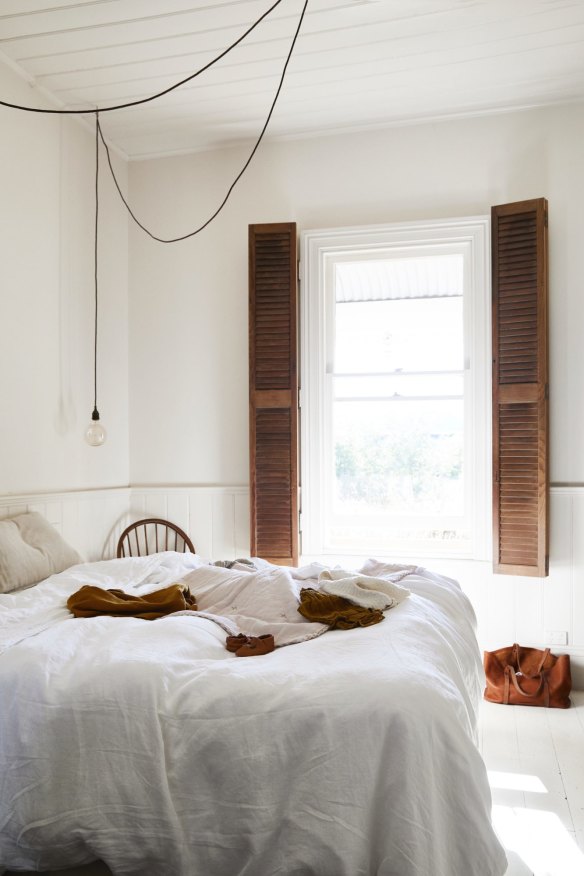 Morning light streams into the main bedroom, which Kali has kept light and bright with white walls and floorboards. Antique wooden shutters and furniture add a warm, rustic feel.